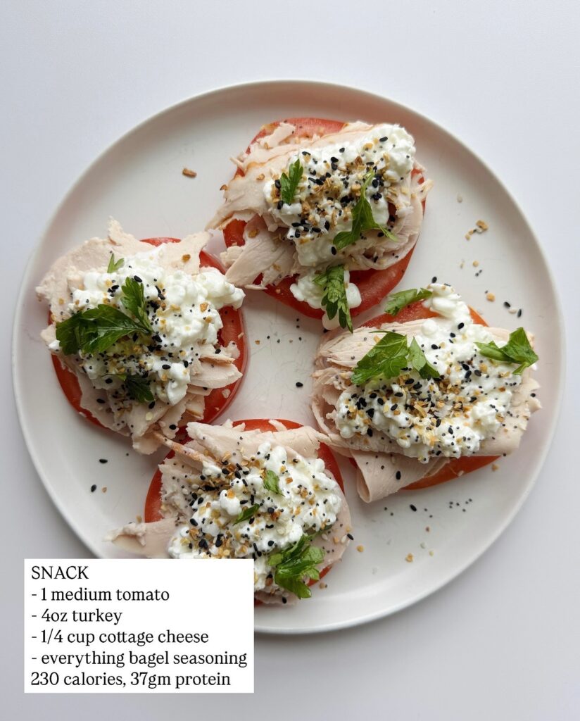 Turkey slices with cottage cheese on tomato slices, topped with everything bagel seasoning and calorie and protein counts.