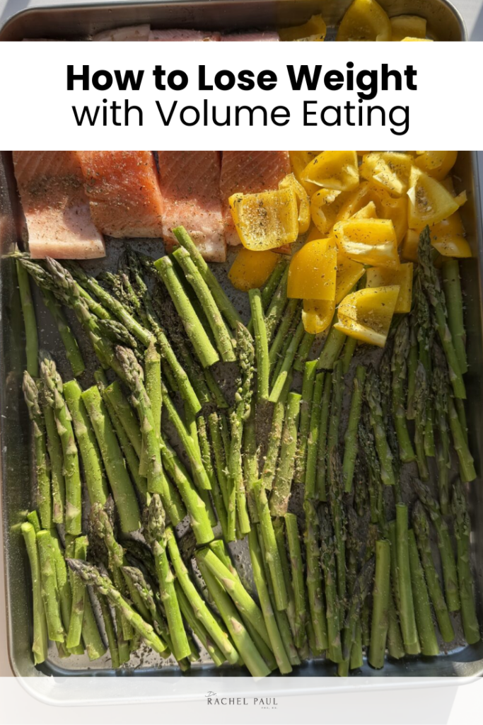 Sheet pan meal with salmon filets, roasted asparagus, and chopped bell peppers, overlaid with text reading "How to Lose Weight with Volume Eating"