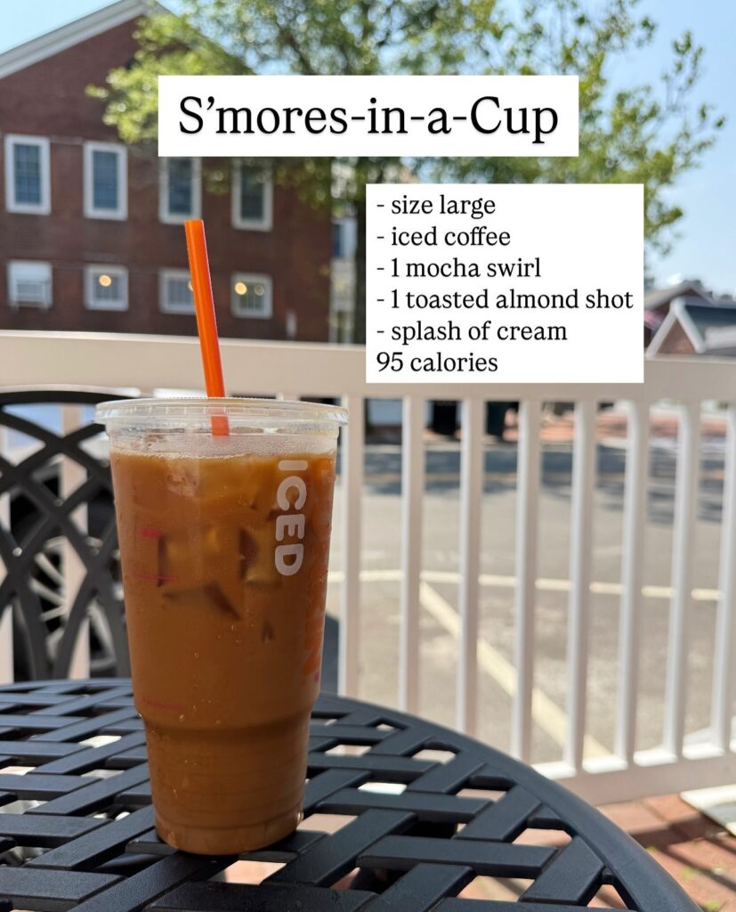 Large Dunkin' iced coffee called Smores-in-a-Cup with mocha swirl, toasted almond flavor shot, splash of cream, and calorie count shown.